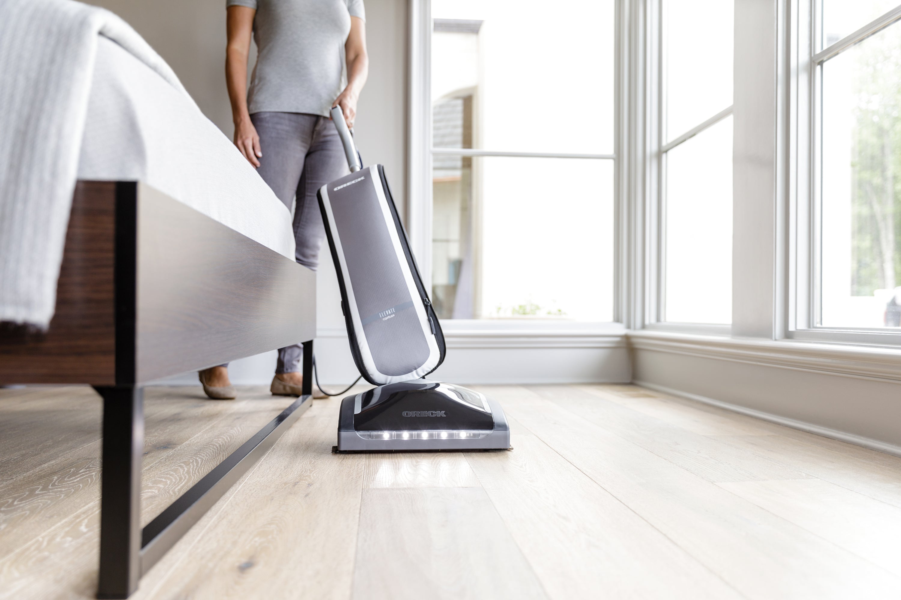 Oreck Elevate Conquer Vacuum on Brown Hardwood Floor