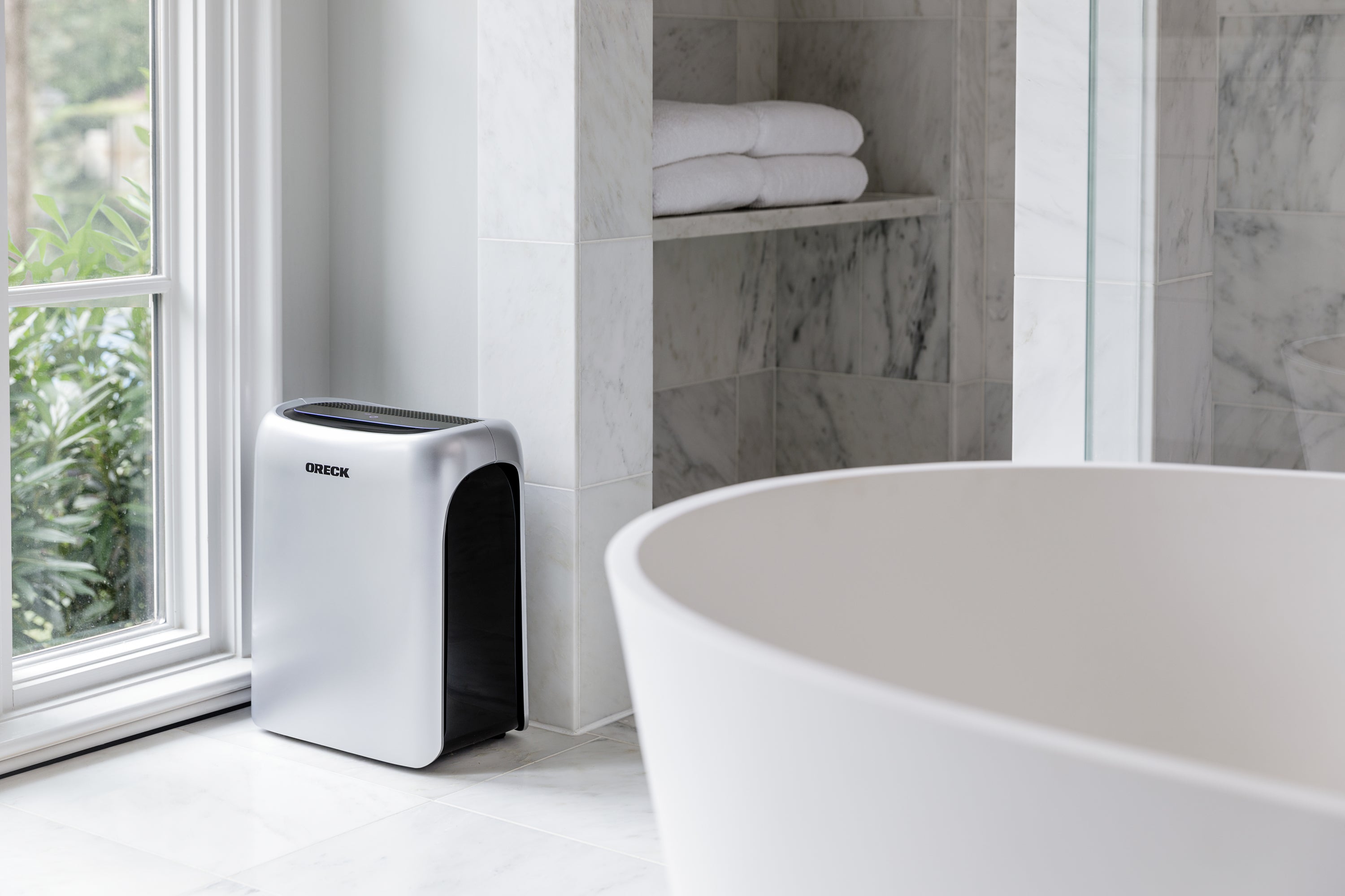 Oreck Medium Air Response Purifier Showcased in Grey Marble Bathroom